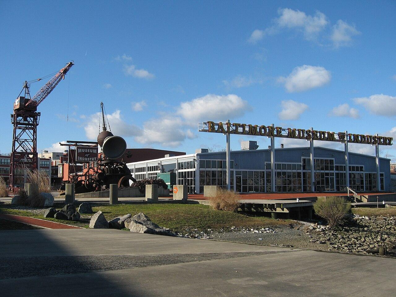 The Baltimore Museum of Industry on Key Highway from the quay, its name along the roofline and an old dockside crane beside it