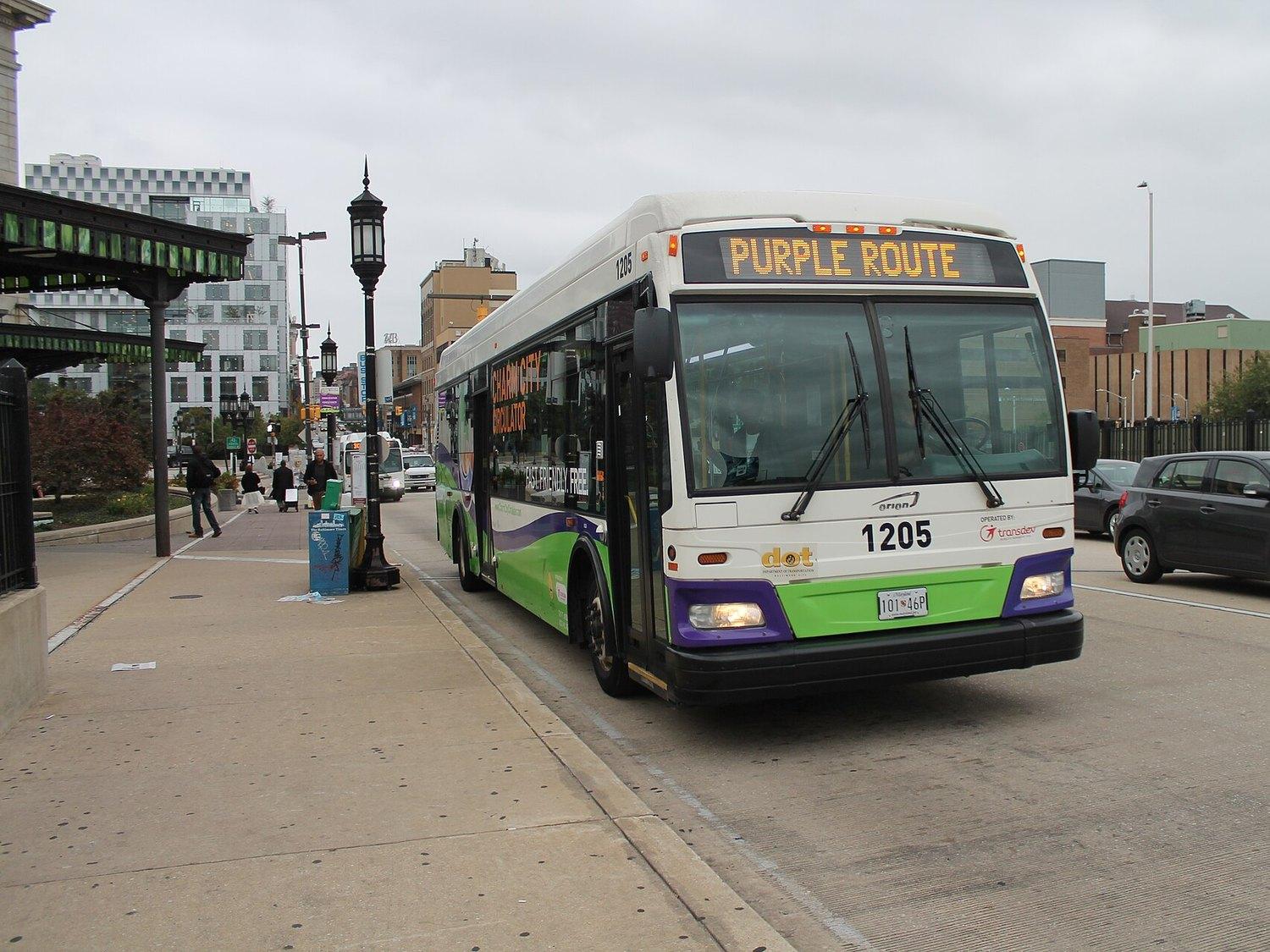 A Charm City Circulator bus on the Purple Route pulling up outside Penn Station