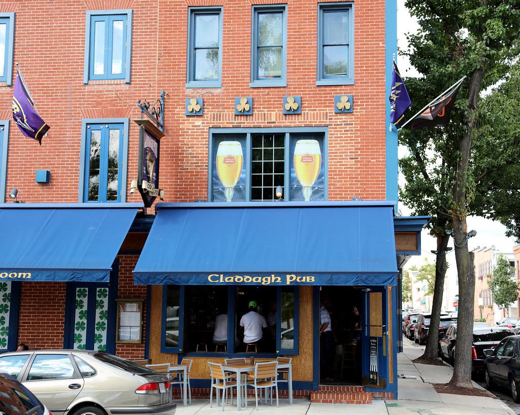 Claddagh Pub's blue awning and shamrock tilework on O'Donnell Square