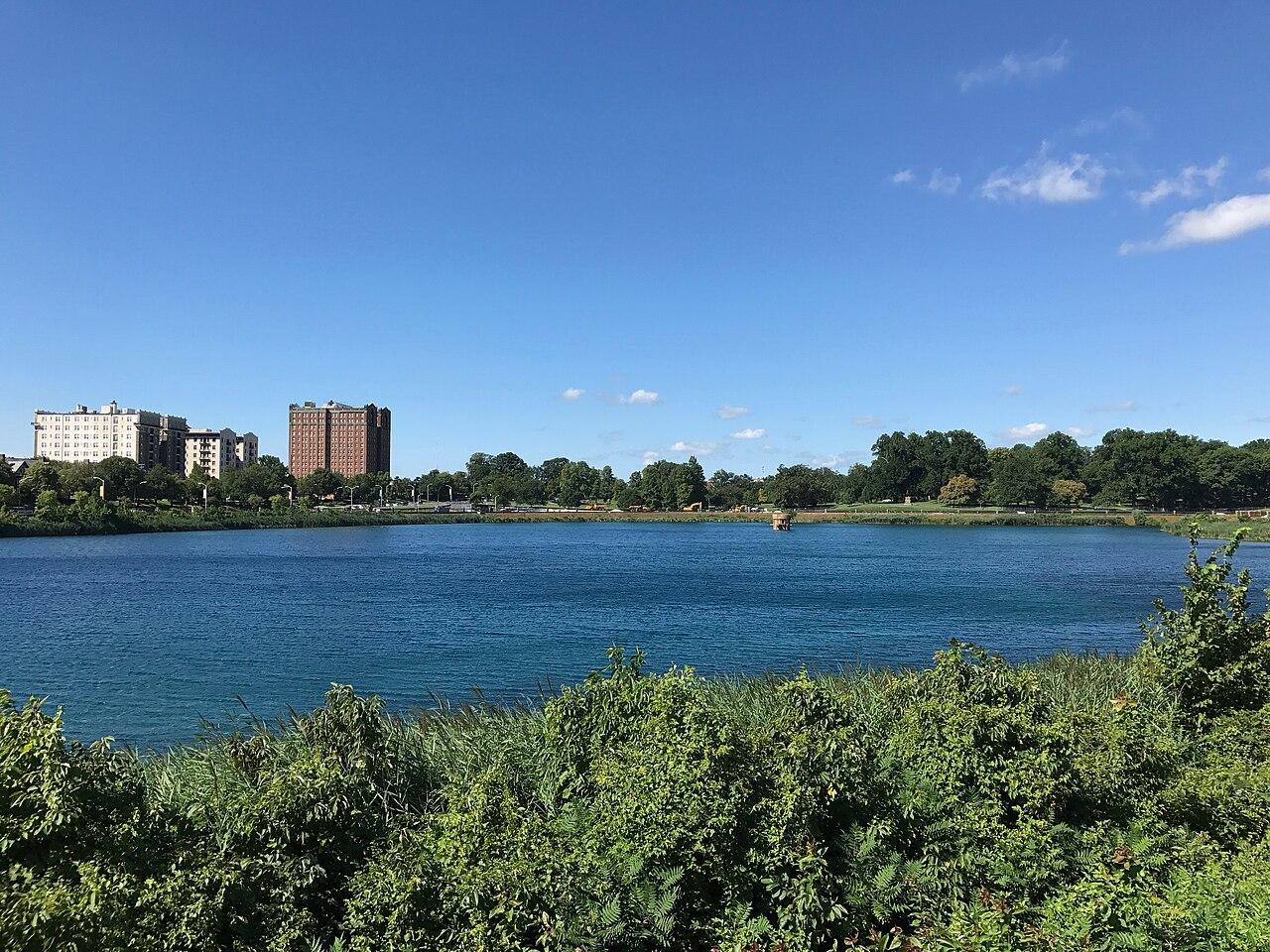 Druid Lake in Druid Hill Park from its north side, Reservoir Hill's towers across the water, photographed in 2017