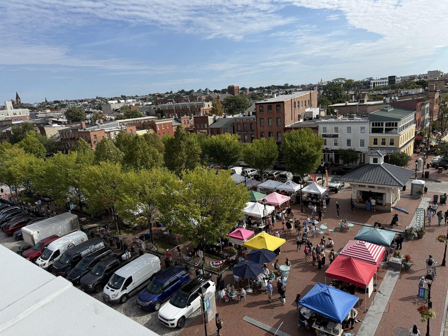 Market stalls filling Broadway Square on a Saturday morning, seen from above
