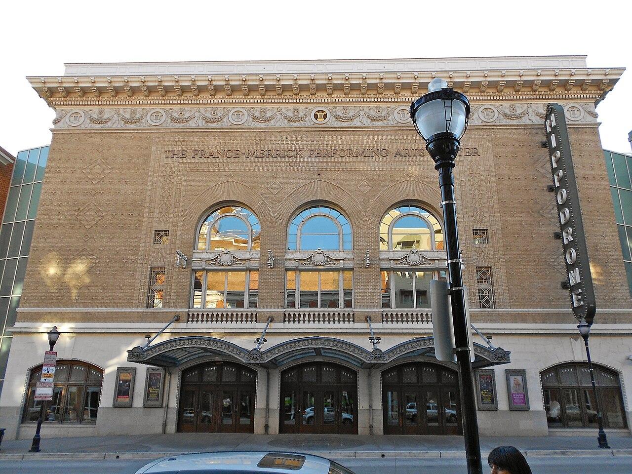 The Hippodrome Theatre's front on North Eutaw Street, with its vertical HIPPODROME sign and the France-Merrick Performing Arts Center name