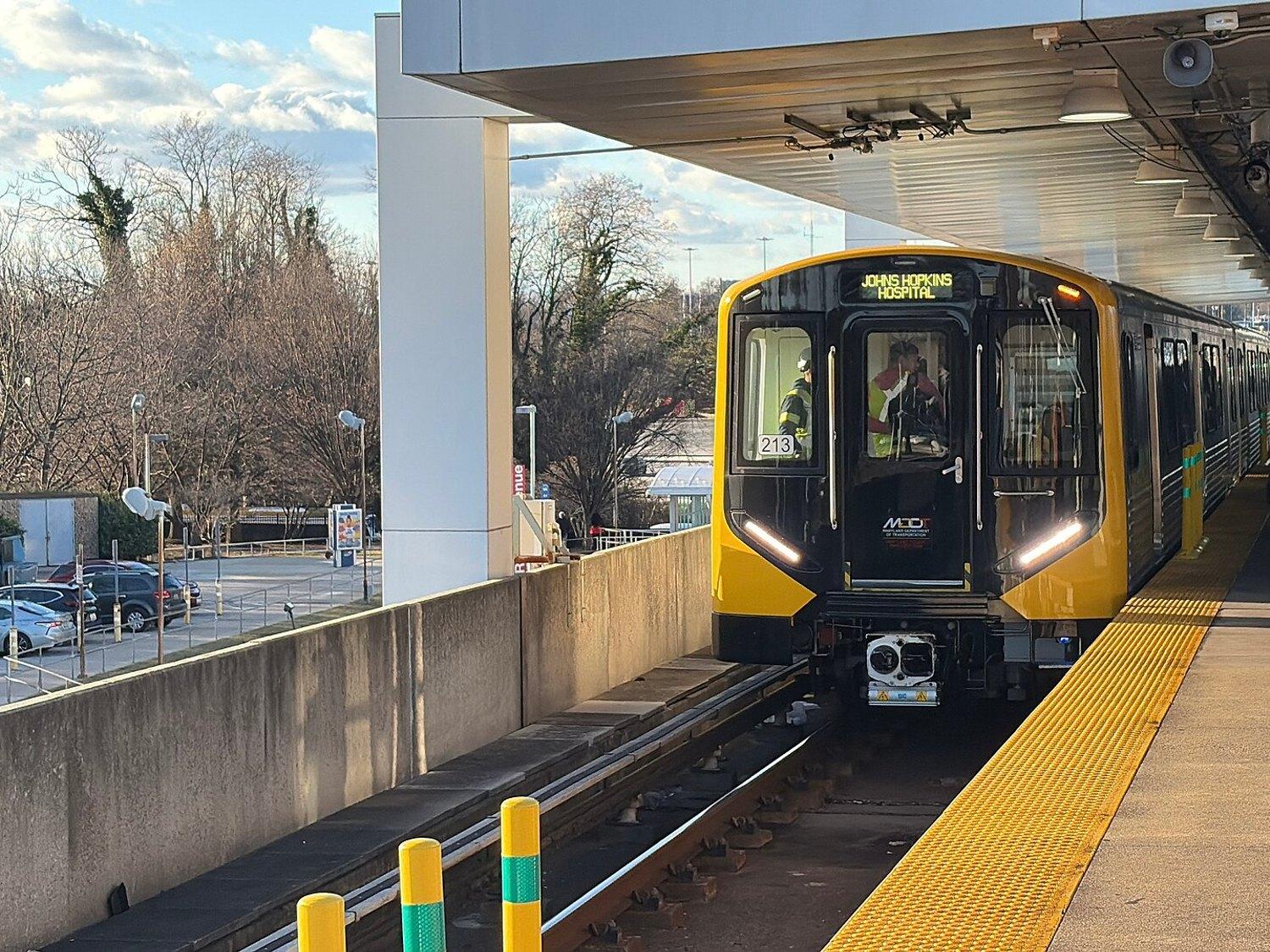 A yellow-fronted Metro SubwayLink train waiting at an open-air platform
