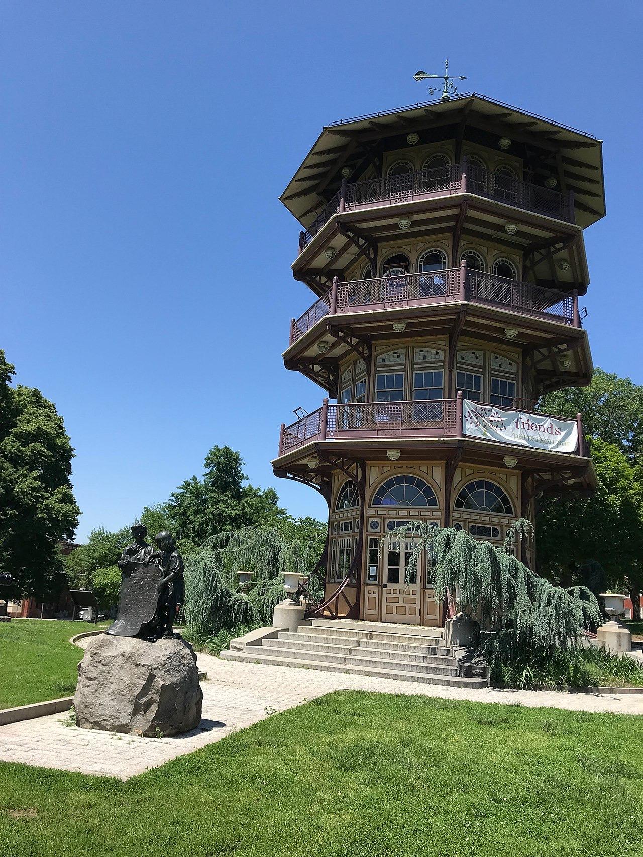 The Patterson Park Pagoda, an eight-sided tower of stacked balconies on a lawn, under a blue sky