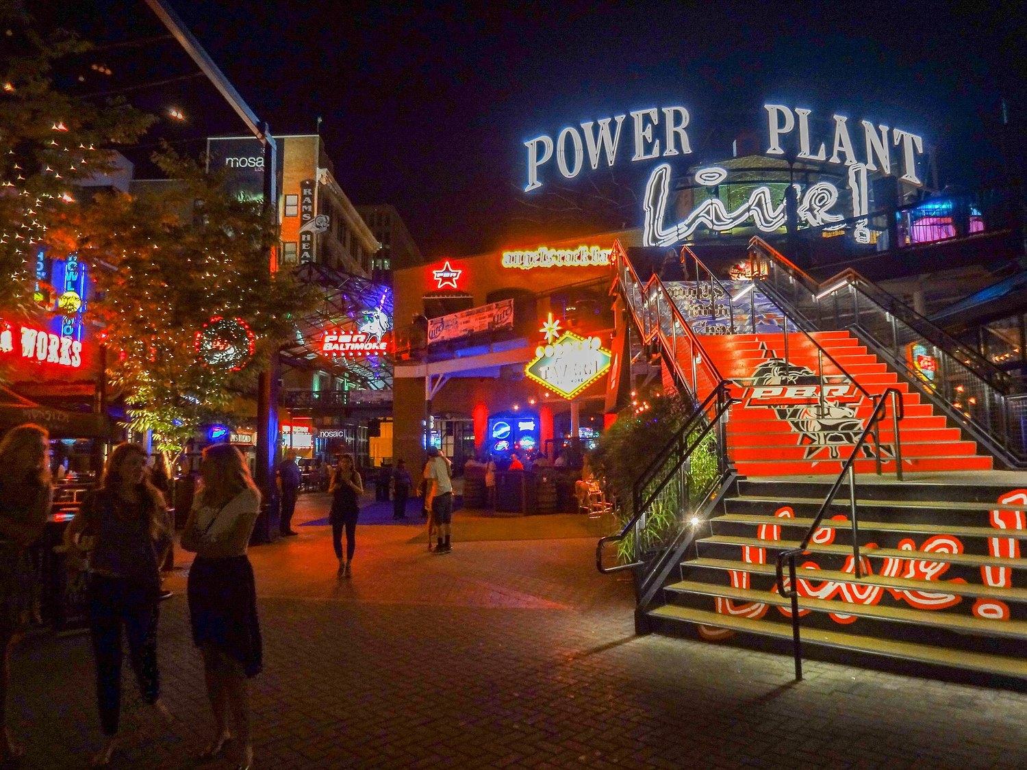 The Power Plant Live courtyard at night, its neon sign above the lit steps