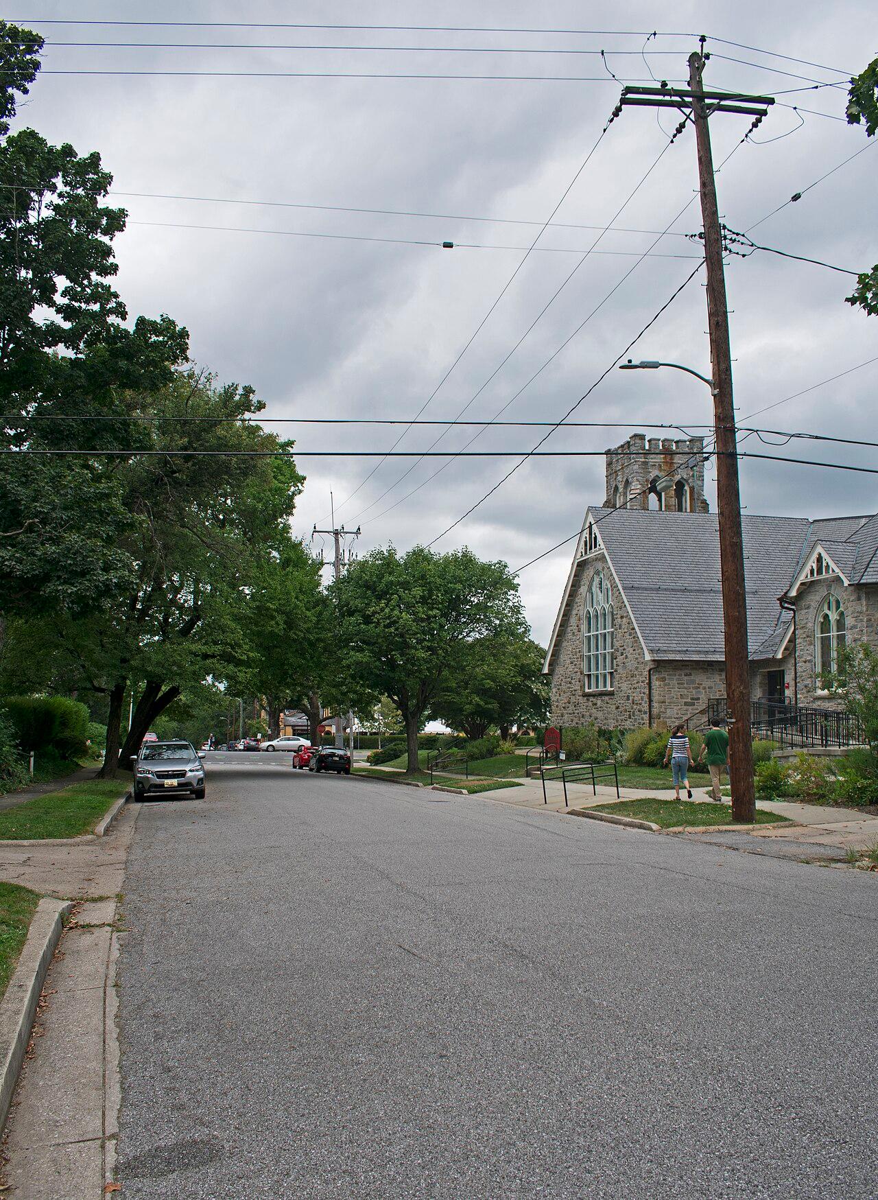 Upland Road in Roland Park, with the stone gable and tower of Roland Park Presbyterian Church at its end