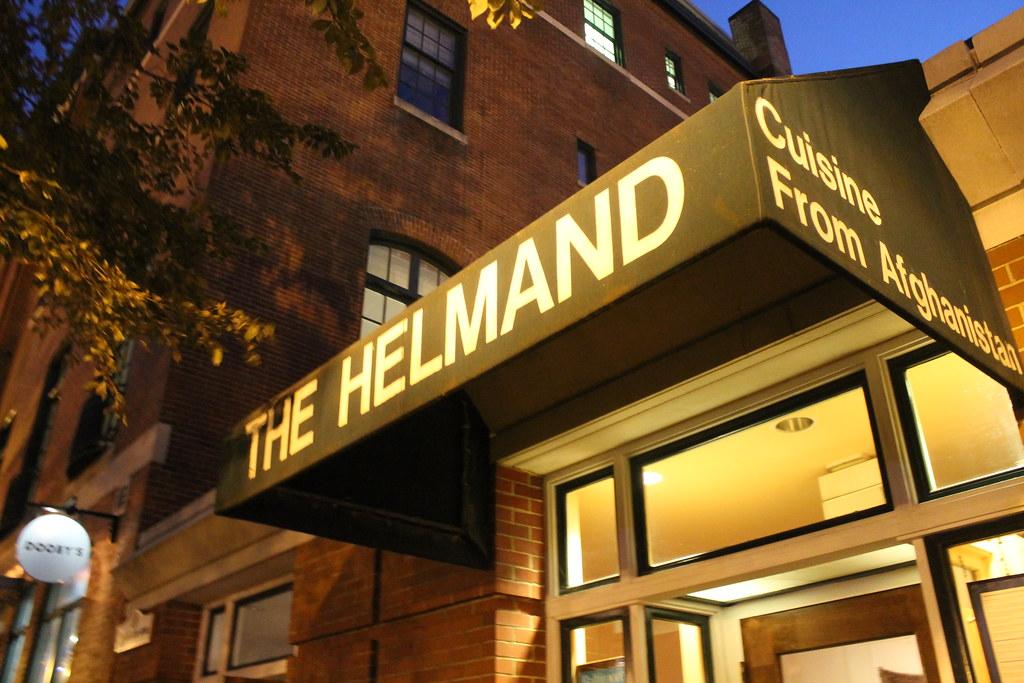 The Helmand's lit awning on North Charles Street at night