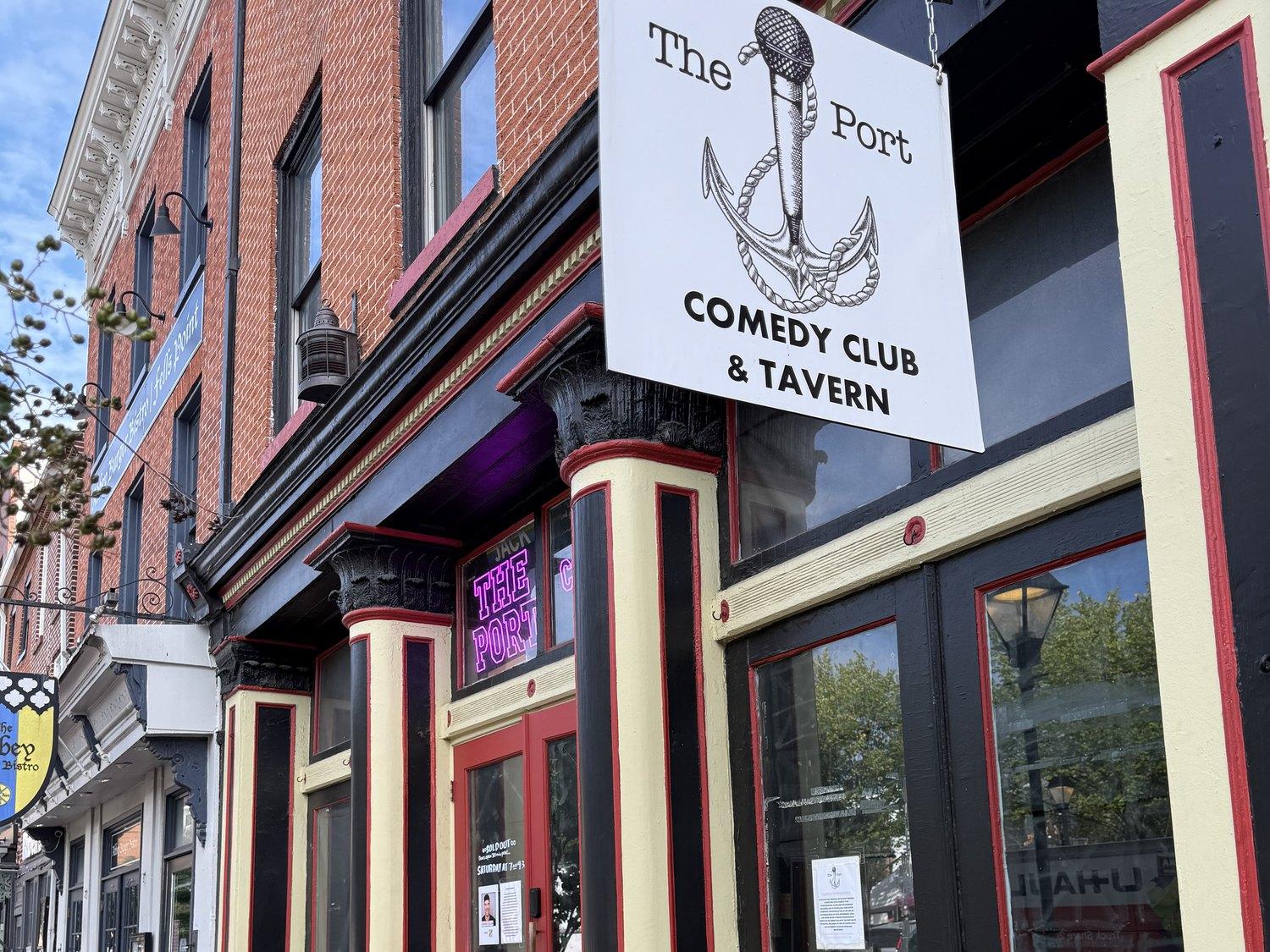 The Port's anchor-and-microphone sign hanging over its red doors on Broadway