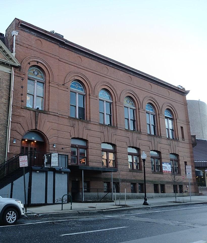 Baltimore Theatre Project on West Preston Street, a red brick building with a row of tall arched windows