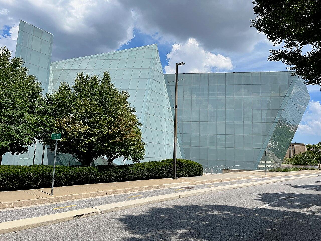 MICA's Brown Center on West Mount Royal Avenue, an angular building wrapped in pale green glass, trees in front