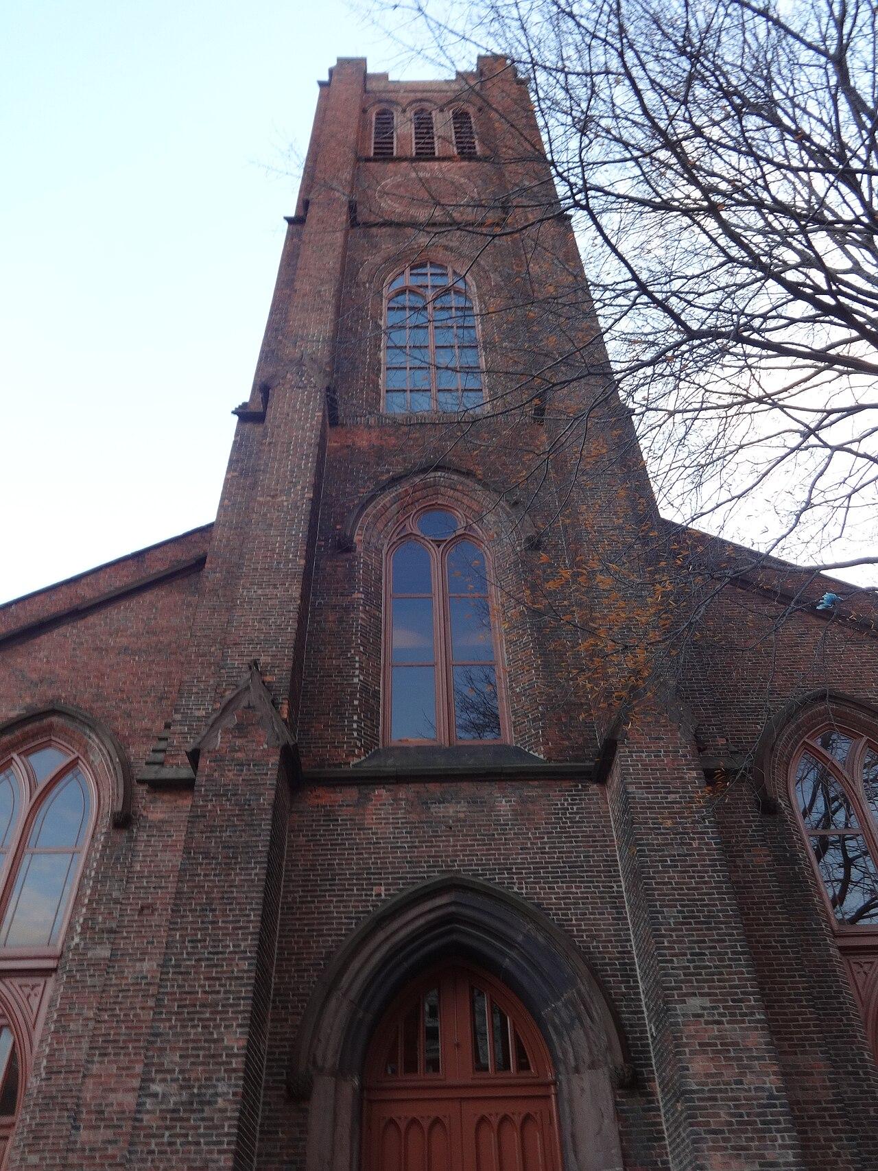 The brick Gothic tower of Westminster Hall on West Fayette Street, looking up from the burying ground